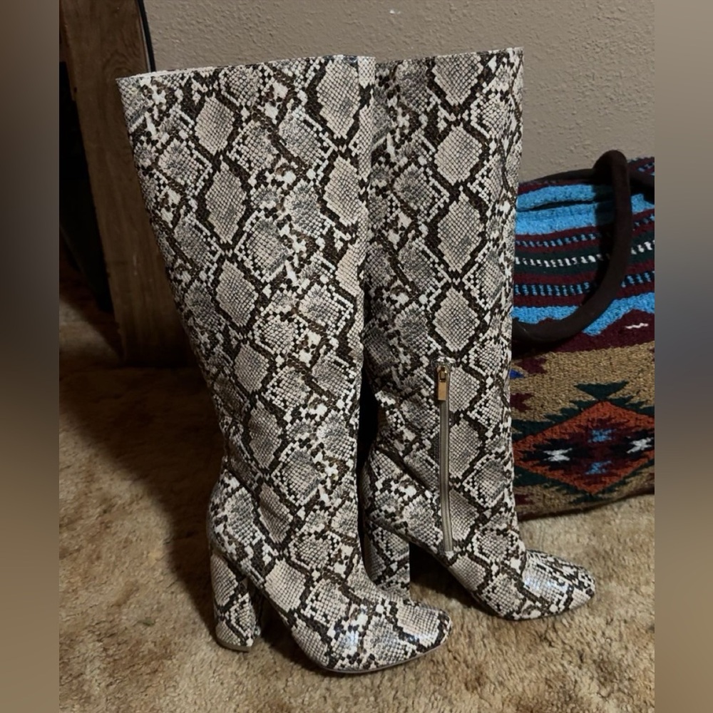 Snake skin boots with a 2 inch heel.